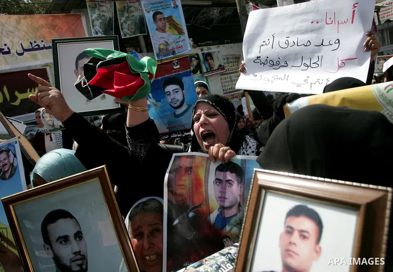 Palestinians hold pictures of their jailed relatives during a rally, one of several taking place across the Israeli occupied West Bank and Gaza Strip, calling for the release of Palestinians being held in Israeli jails,...