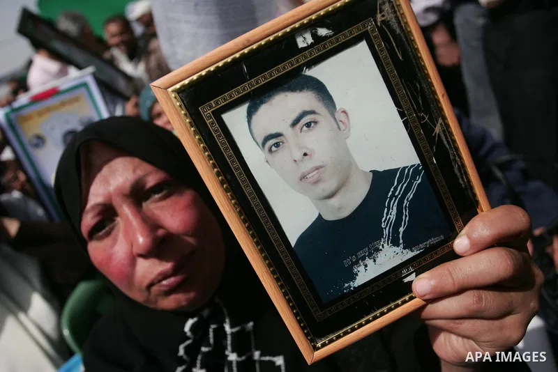 Palestinians hold pictures of their jailed relatives during a rally, one of several taking place across the Israeli occupied West Bank and Gaza Strip, calling for the release of Palestinians being held in Israeli jails,...