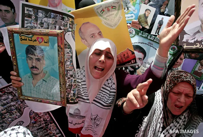 Palestinians hold pictures of their jailed relatives during a rally, one of several taking place across the Israeli occupied West Bank and Gaza Strip, calling for the release of Palestinians being held in Israeli jails,...