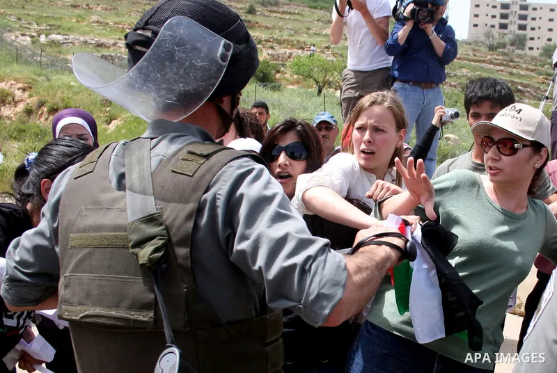 Palestinians and foreigners argue with Israeli soldiers during a protest outside Ofer prison, near the West Bank city of Ramallah, April 17, 2011, calling for the release of Palestinian prisoners from Israeli jails. Apri...