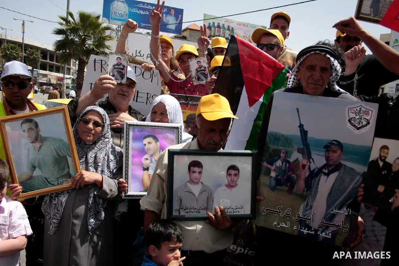 Palestinians take part in a rally, one of several taking place across the Israeli occupied West Bank and Gaza Strip calling for the release of Palestinians being held in Israeli jails, as they mark Palestinian Prisoner's...