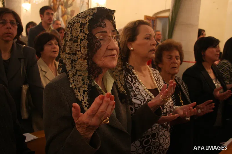 Palestinian Christians take part on Orthodox Palm Sunday in the West Bank city of Ramallah, Sunday, April 17, 2011. Palm Sunday commemorates Jesus Christ's triumphant entry into Jerusalem, and is the start of the church'...