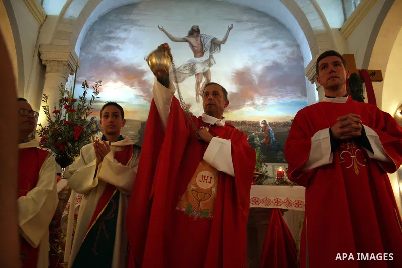 Palestinian Christians take part on Orthodox Palm Sunday in the West Bank city of Ramallah, Sunday, April 17, 2011. Palm Sunday commemorates Jesus Christ's triumphant entry into Jerusalem, and is the start of the church'...