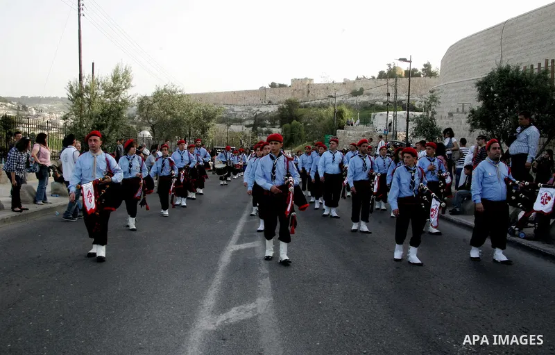 Christian scouts take part in the Palm Sunday procession from Mt. Olives into Jerusalem's old city on April 17, 2011, marking the triumphant return of Jesus Christ to Jerusalem when a cheering crowd greeted him waving pa...