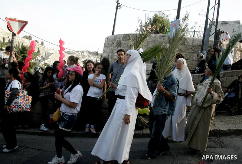 Christian pilgrims take part the Palm Sunday procession from Mt. Olives into Jerusalem's old city on April 17, 2011, marking the triumphant return of Jesus Christ to Jerusalem when a cheering crowd greeted him waving pal...