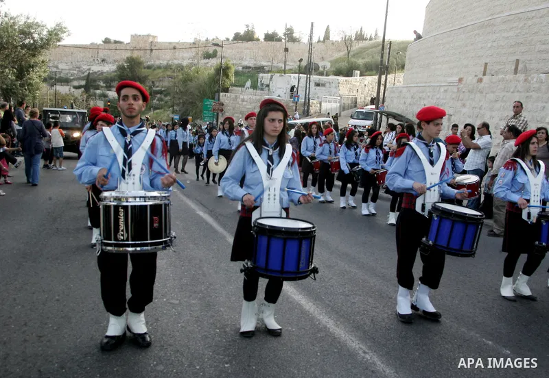 Christian scouts take part in the Palm Sunday procession from Mt. Olives into Jerusalem's old city on April 17, 2011, marking the triumphant return of Jesus Christ to Jerusalem when a cheering crowd greeted him waving pa...