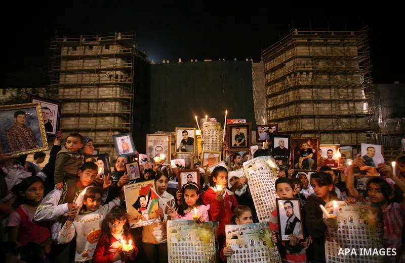 Palestinians light candles during a protest to mark Prisoner's Day in front Damascus Gate in Jerusalem's old city, Sunday, April 17, 2011. Some 5,500 Palestinians are held in Israeli prisons according to figures compiled...
