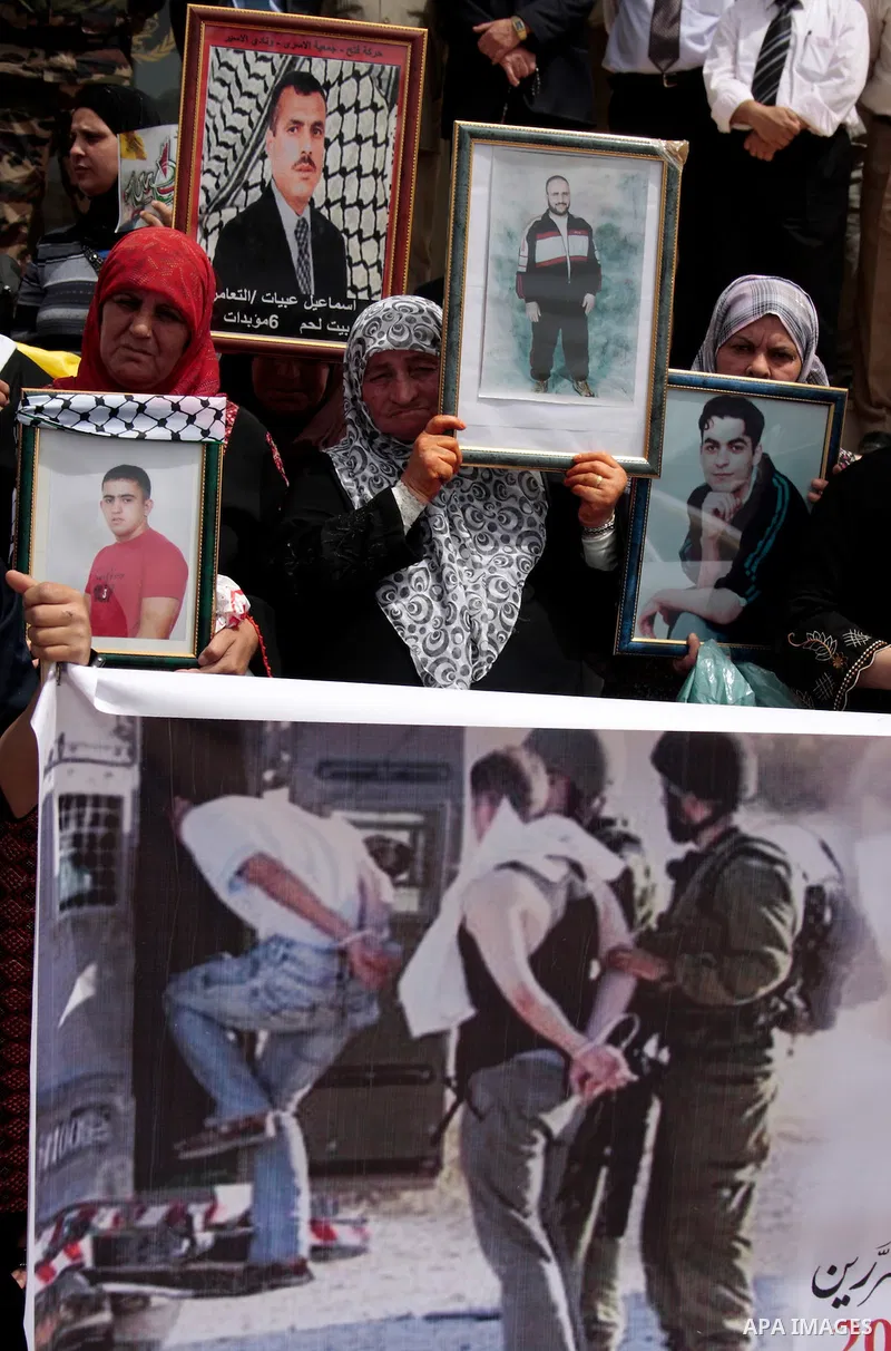 Palestinians hold up a photo of jailed family members as they take part in a rally, one of several taking place across the Israeli occupied West Bank and Gaza Strip, calling for the release of Palestinians being held in...