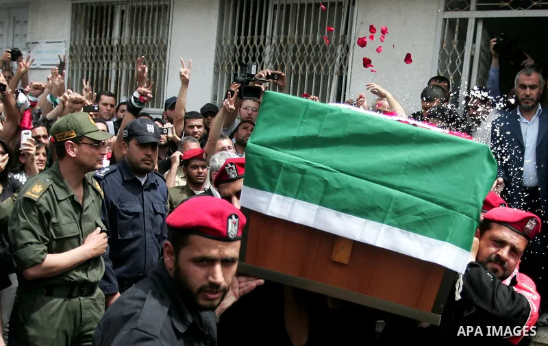 Palestinian Hamas security personnel carry the coffin of the pro-Palestinian Italian activist Vittorio Arrigoni during his funeral in Gaza City, Gaza Strip, 18 April 2011. After the funeral, the body of Vittorio Arrigoni...