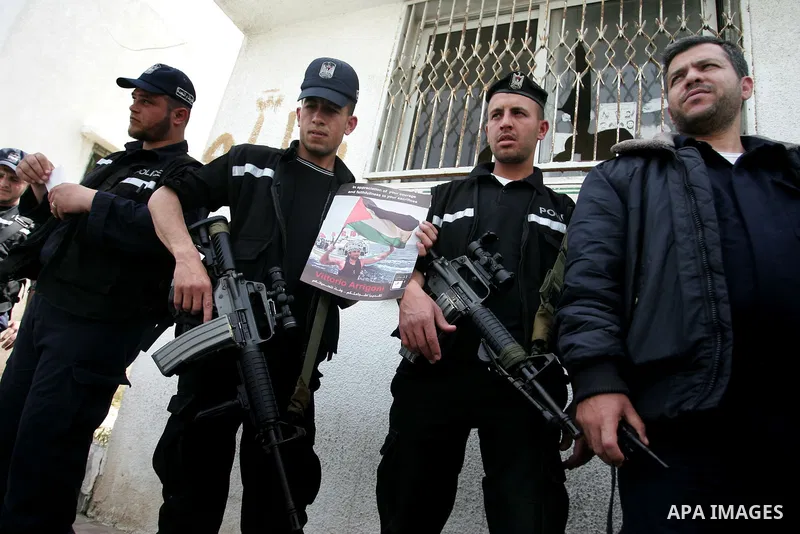 Members of Hamas' security forces hold back Palestinians reacting after the coffin of Italian activist Vittorio Arrigoni was taken out of al-Shifa hospital in Gaza City April 18, 2011. Friends of the Italian activist Arr...