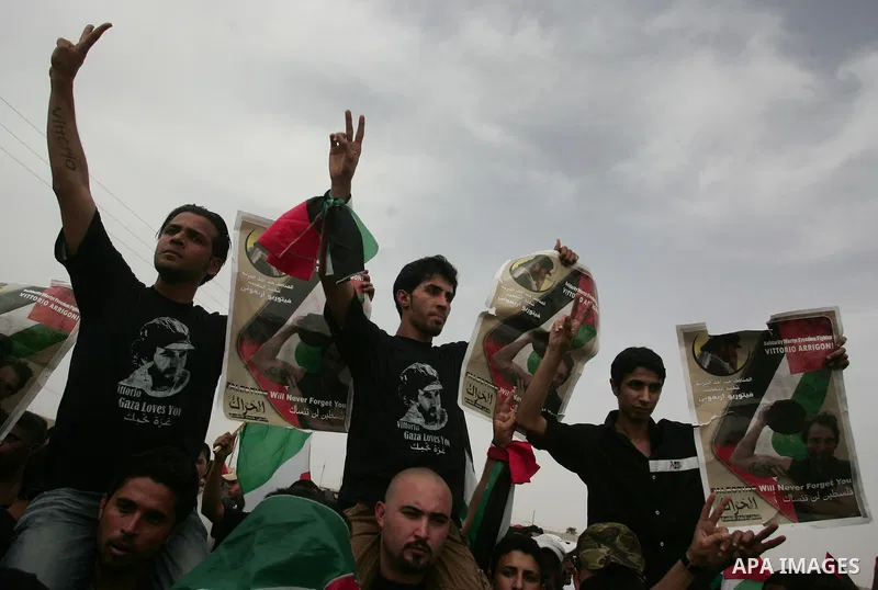 Palestinians chant slogans while carrying the coffin of Italian activist Vittorio Arrigoni, age 36, as they transfer it through Rafah border crossing in southern Gaza Strip, Monday, April 18, 2011. Gaza's Hamas governmen...
