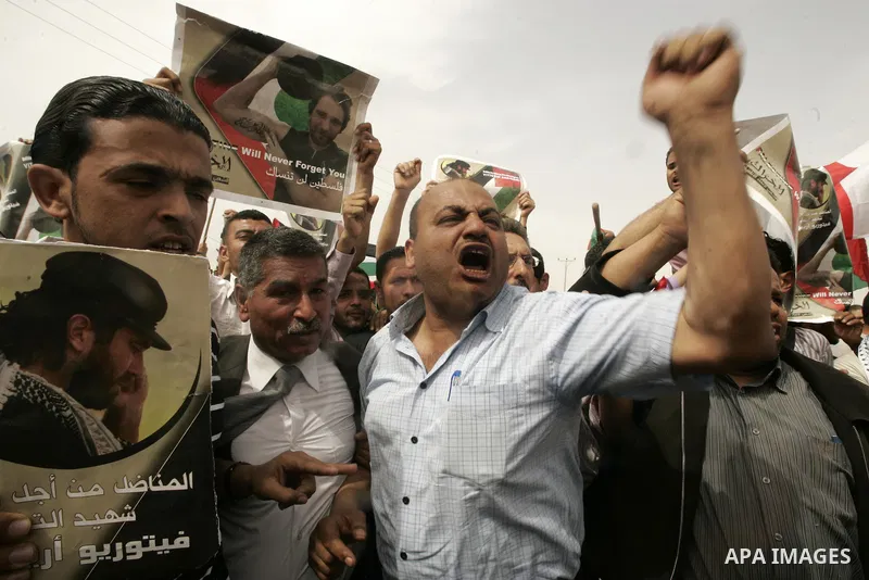 Palestinians and foreigners mourn during the "state funeral" of Italian activist Vittorio Arrigoni in Rafah, southern Gaza Strip, on April 18, 2011 before the transferring of his body to Egypt via the Rafah border crossi...