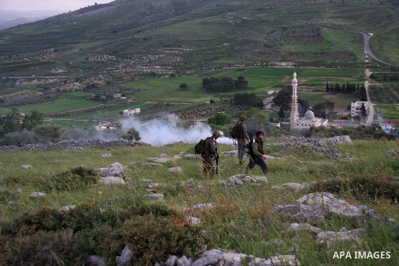 Israeli soldiers arrive at the scene during stone throwing clashes between Jewish settlers from the Har Bracha settlement and local Palestinian villagers close to Burin in the Israeli occupied West Bank on April 19, 2011...