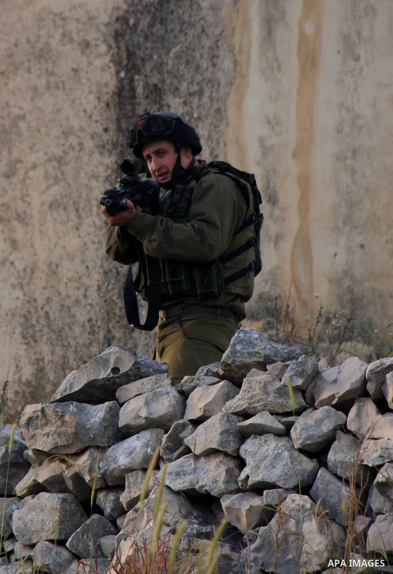 Israeli soldiers arrive at the scene during stone throwing clashes between Jewish settlers from the Har Bracha settlement and local Palestinian villagers close to Burin in the Israeli occupied West Bank on April 19, 2011...