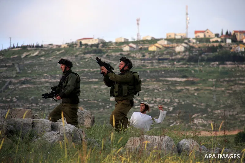 Israeli soldiers arrive at the scene during stone throwing clashes between Jewish settlers from the Har Bracha settlement and local Palestinian villagers close to Burin in the Israeli occupied West Bank on April 19, 2011...
