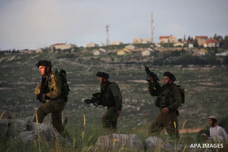Israeli soldiers arrive at the scene during stone throwing clashes between Jewish settlers from the Har Bracha settlement and local Palestinian villagers close to Burin in the Israeli occupied West Bank on April 19, 2011...