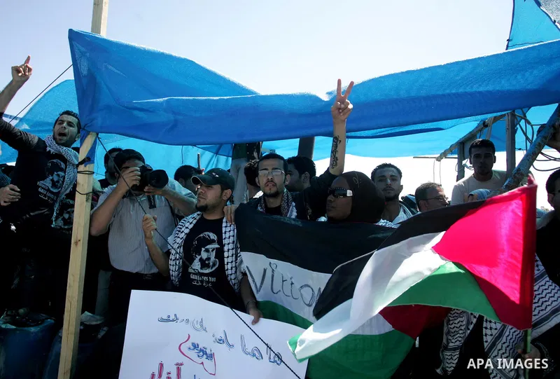 Palestinian and foreign activists protest against the kidnapping and killing of Italian human rights activist Vittorio Arrigoni by a Salafist group of radical Islamist at the port in Gaza City, on April 20, 2011, a day a...
