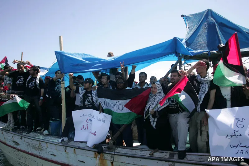 Palestinian and foreign activists protest against the kidnapping and killing of Italian human rights activist Vittorio Arrigoni by a Salafist group of radical Islamist at the port in Gaza City, on April 20, 2011, a day a...