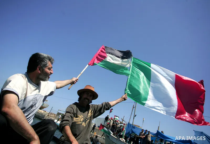 Palestinian and foreign activists protest against the kidnapping and killing of Italian human rights activist Vittorio Arrigoni by a Salafist group of radical Islamist at the port in Gaza City, on April 20, 2011, a day a...