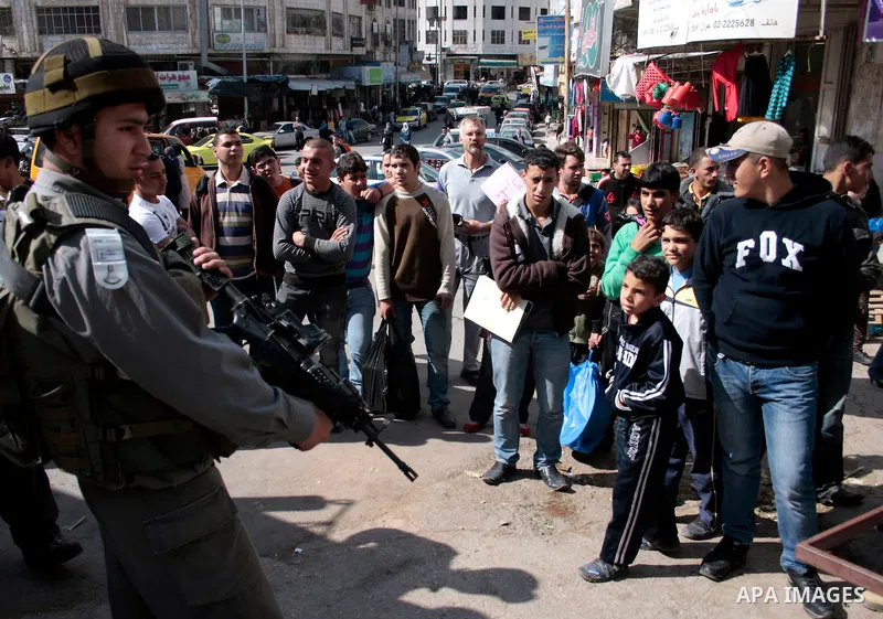 Israeli soldiers stand guard in an empty street in Hebron in the occupied West Bank on April 20, 2011. The Israeli army imposed a temporary curfew on Palestinians in the city centre to allow Jewish settlers to visit the...