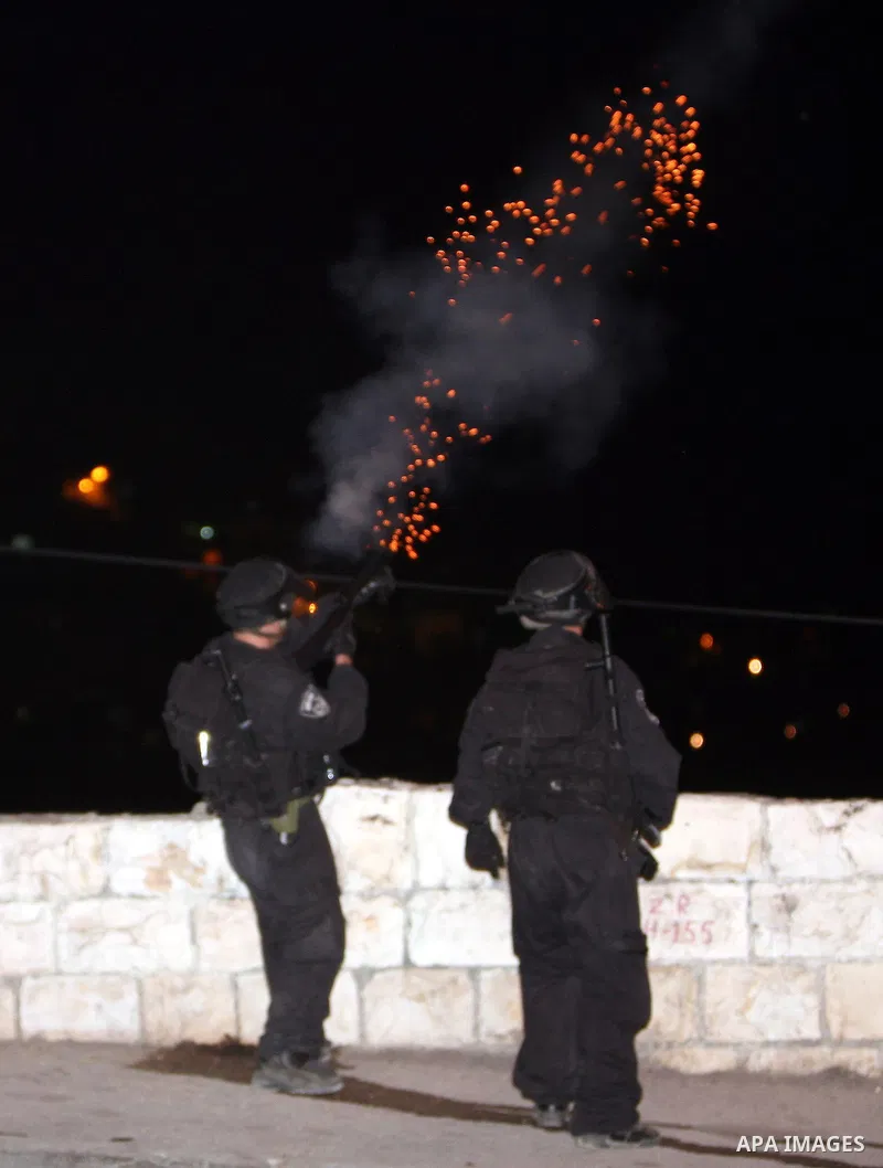 Israeli soldiers fire tear gas canisters toward Palestinian youths during the clashes in the Jerusalem neighbourhood of Silwan on April 20,2011. Photo by Sliman Khader