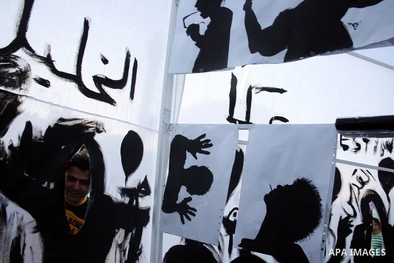 Palestinians participate in exhibition organized by students from Birzeit University in the West Bank city of Ramallah on April 20,2011, in cooperation with Belgium's Lacambre University. The exhibition was erected in th...