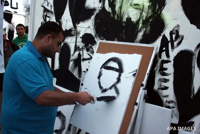Palestinians participate in exhibition organized by students from Birzeit University in the West Bank city of Ramallah on April 20,2011, in cooperation with Belgium's Lacambre University. The exhibition was erected in th...