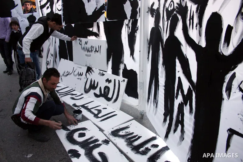 Palestinians participate in exhibition organized by students from Birzeit University in the West Bank city of Ramallah on April 20,2011, in cooperation with Belgium's Lacambre University. The exhibition was erected in th...