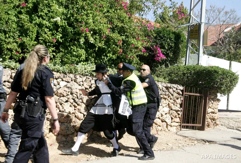 Ultra-Orthodox demonstrators scuffle with police during a protest near Tel Aviv April 21, 2011. protest against the excavation of graves. photo by MAhfouz Abu Turk
