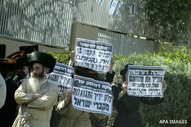 Ultra-Orthodox demonstrators scuffle with police during a protest near Tel Aviv April 21, 2011. protest against the excavation of graves. photo by MAhfouz Abu Turk