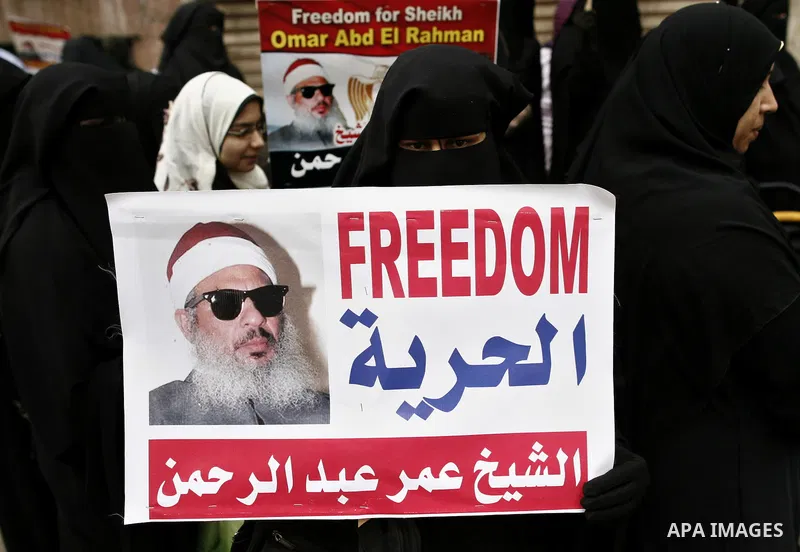 Supporters of Egyptian cleric Sheikh Omar Abdel Rahman hold banners as they demonstrate to call for his release in front of the U.S. embassy in Cairo on April 21, 2011. Abdel-Rahman, was jailed for life in January 1996 f...