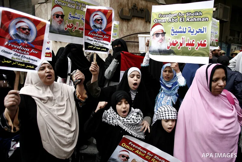 Supporters of Egyptian cleric Sheikh Omar Abdel Rahman hold banners as they demonstrate to call for his release in front of the U.S. embassy in Cairo on April 21, 2011. Abdel-Rahman, was jailed for life in January 1996 f...