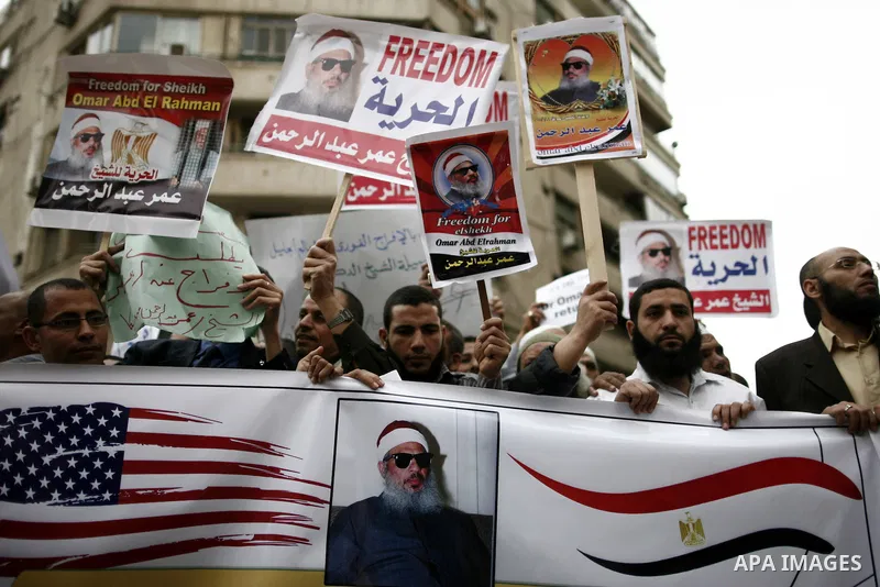 Supporters of Egyptian cleric Sheikh Omar Abdel Rahman hold banners as they demonstrate to call for his release in front of the U.S. embassy in Cairo on April 21, 2011. Abdel-Rahman, was jailed for life in January 1996 f...