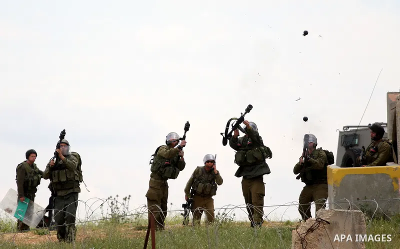 Israeli soldiers fire tear gas canisters toward protesters during the weekly demonstration against Israel's controversial separation barrier in the village of Bilin, near the West Bank city of Ramallah on April 22, 2011....