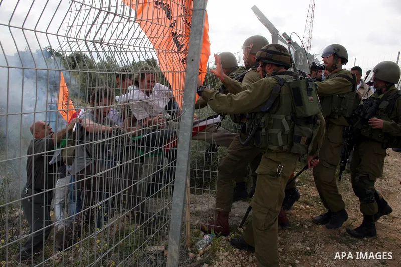 Israeli soldiers scuffle with Palestinian and foreign protesters during the weekly demonstration against Israel's controversial separation barrier in the village of Bilin, near the West Bank city of Ramallah on April 22,...