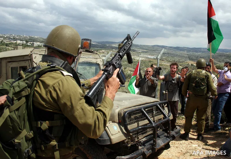 Israeli soldiers scuffle with Palestinian and foreign protesters during the weekly demonstration against Israel's controversial separation barrier in the village of Bilin, near the West Bank city of Ramallah on April 22,...