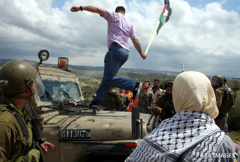 Israeli soldiers scuffle with Palestinian and foreign protesters during the weekly demonstration against Israel's controversial separation barrier in the village of Bilin, near the West Bank city of Ramallah on April 22,...