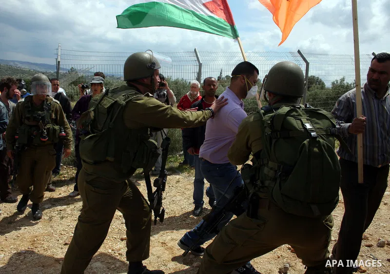 Israeli soldiers scuffle with Palestinian and foreign protesters during the weekly demonstration against Israel's controversial separation barrier in the village of Bilin, near the West Bank city of Ramallah on April 22,...