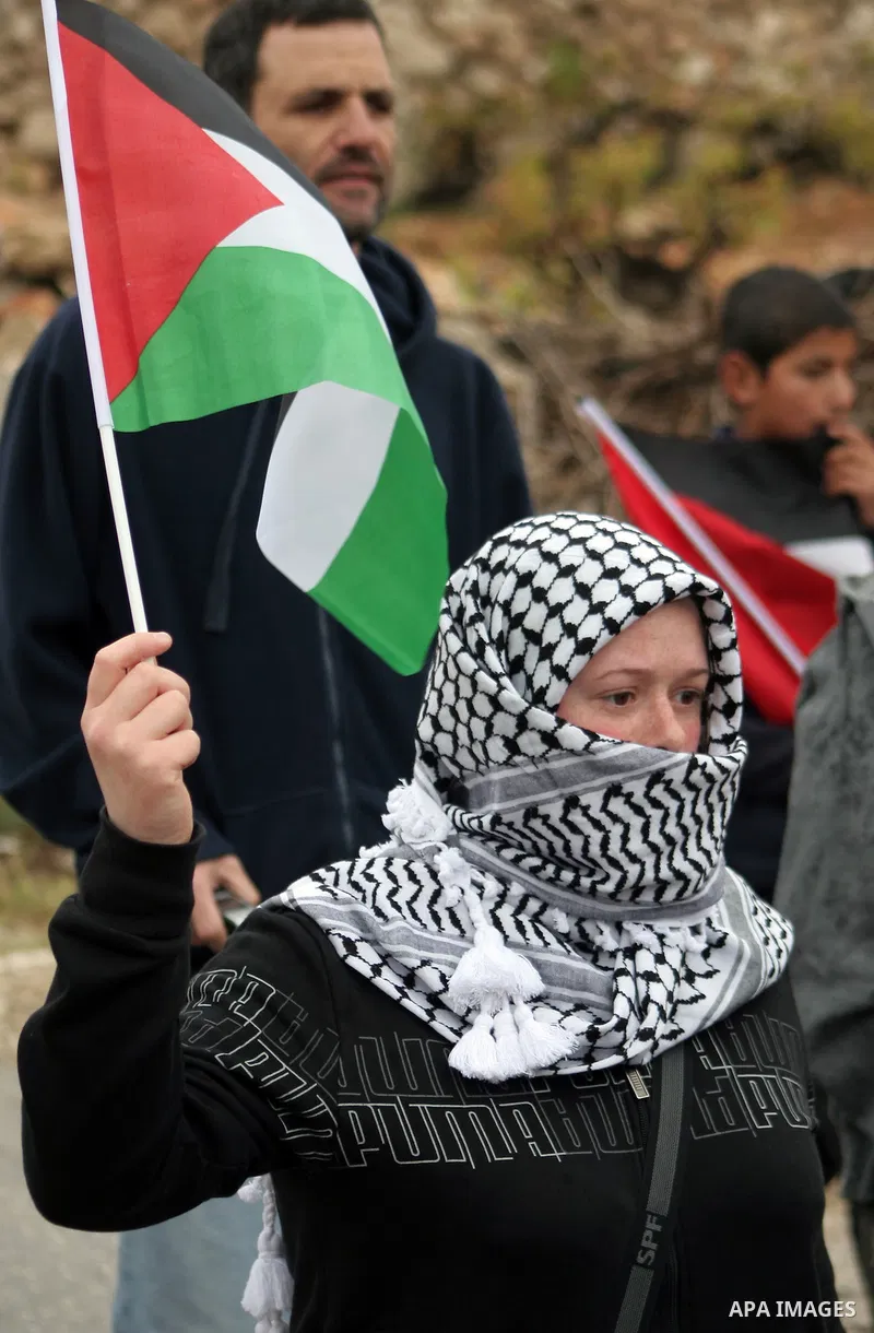Protesters argue with an Israeli soldier during a demonstration against Israel's controversial separation barrier in the West Bank village of Maasarah, near the biblical town of Bethlehem on April 22, 2011.Israel says th...