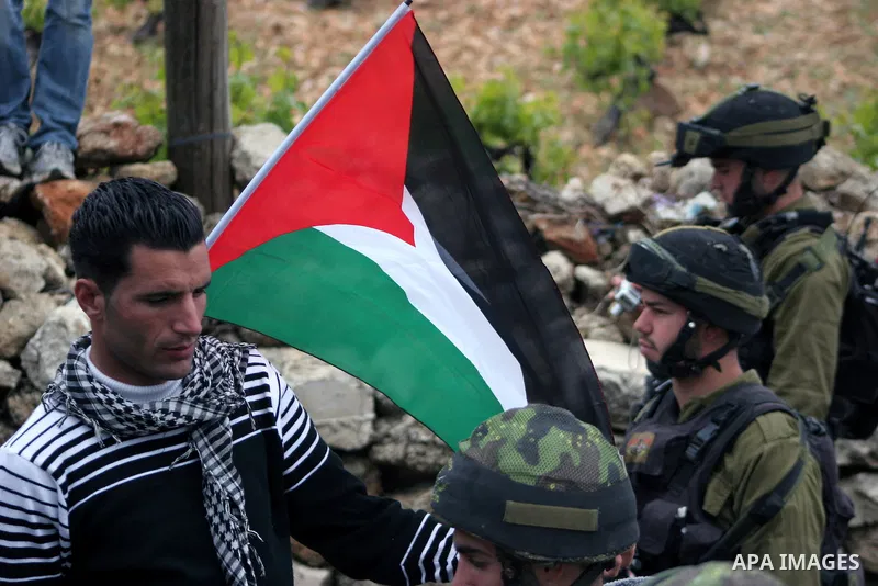 Protesters argue with an Israeli soldier during a demonstration against Israel's controversial separation barrier in the West Bank village of Maasarah, near the biblical town of Bethlehem on April 22, 2011.Israel says th...