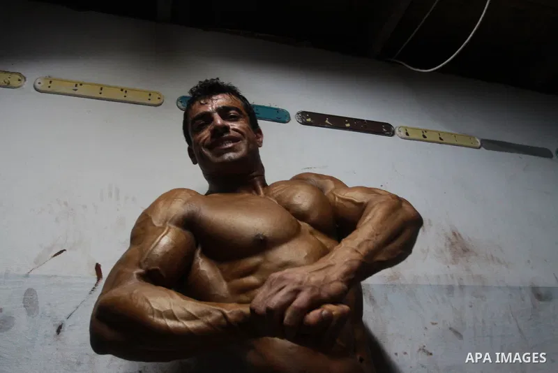 Palestinian men take part during competing in a bodybuilding contest at a hall in Gaza city, Friday, April 22, 2011. Many of the men use women's cosmetics, mud, or paint to enhance their muscles. Number of men from aroun...