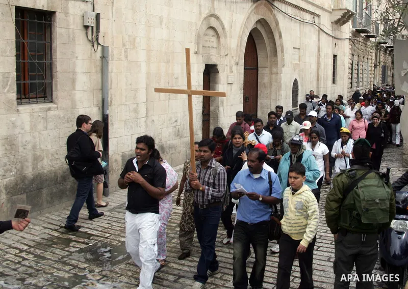 Eastern Orthodox Christians line up as they hold their crosses prior to the start of the Good Friday procession to the Church of the Holy Sepulchre, traditionally regarded as the site of Jesus' crucifixion, burial and re...