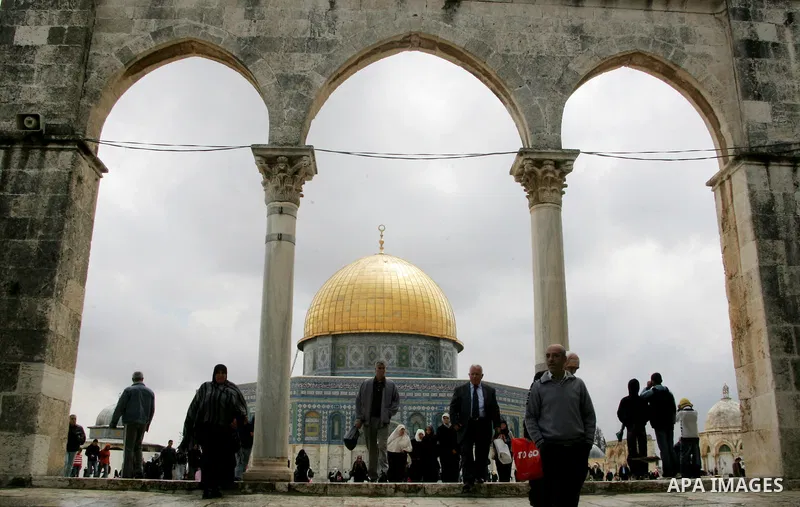 Palestinians walk in front of the Dome of the Rock on the compound known to Muslims as al-Haram al-Sharif, and to Jews as Temple Mount in Jerusalem's Old City April 23, 2011. photo by MAhfouz Abu Turk
