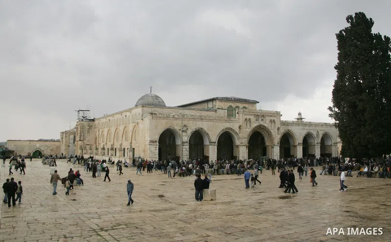 Palestinians walk in front Al-Aqsa Mosque on the compound known to Muslims as al-Haram al-Sharif, and to Jews as Temple Mount in Jerusalem's Old City April 23, 2011. photo by MAhfouz Abu Turk