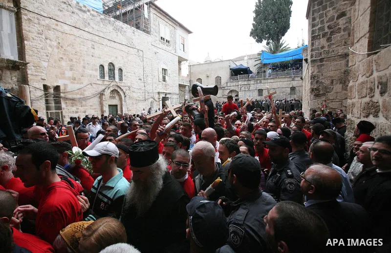 Christians Orthodox take part in Easter "Holy Fire" celebrations on the eve of Easter Sunday on April 23, 2011, outside the Church of the Holy Sepulchre, built over the sites where Christians believe Christ was crucified...