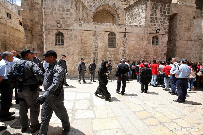 Israeli soldiers stand guard as Christians Orthodox take part in Easter "Holy Fire" celebrations on the eve of Easter Sunday on April 23, 2011, outside the Church of the Holy Sepulchre, built over the sites where Christi...