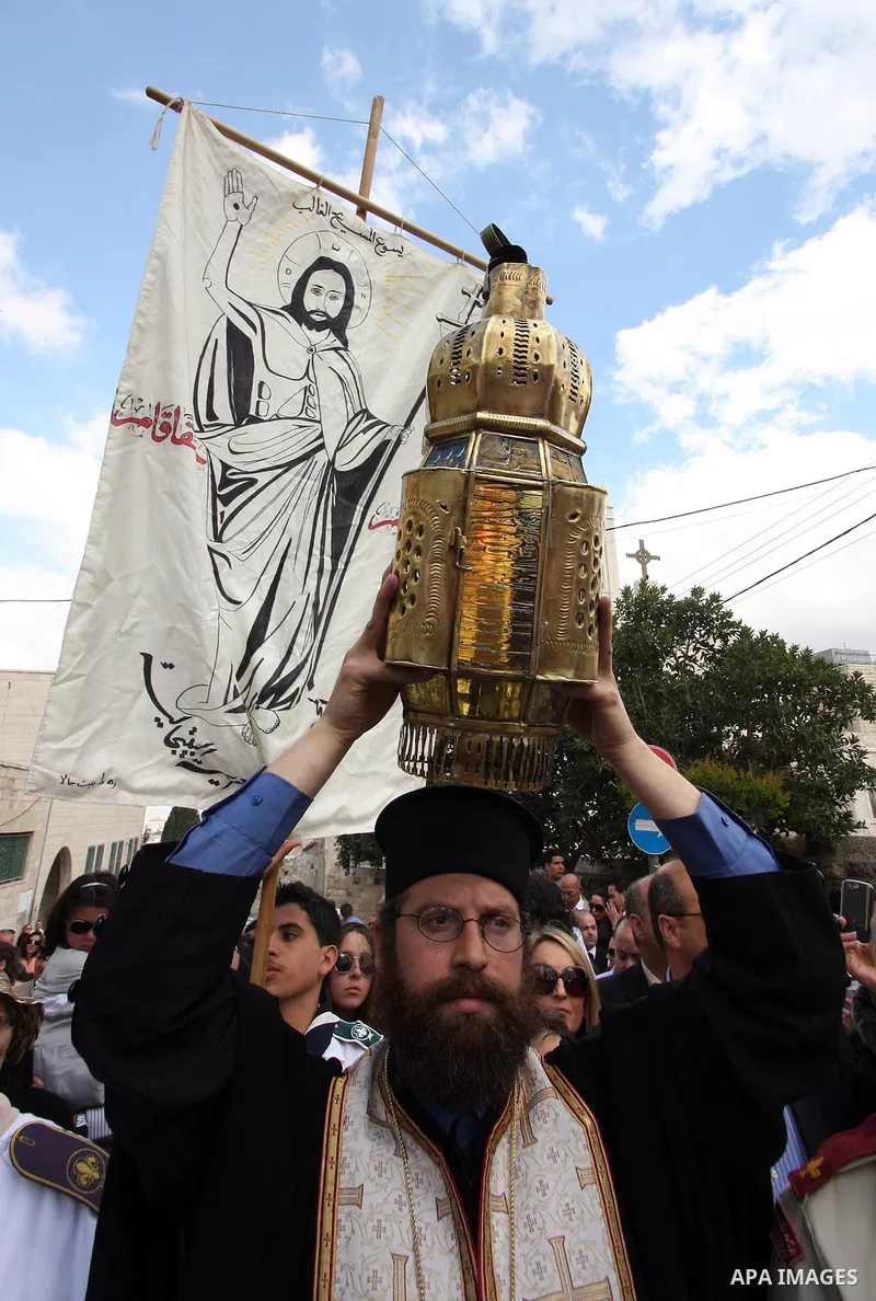 Christians take part in the opening of the Easter Vigil on Holy Saturday late April 23, 2011 in the West Bank town of Beit Jala. Christians of the western church are making their preparations for tomorrow's Easter celebr...