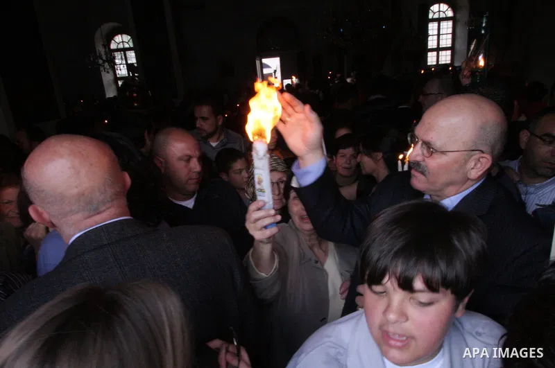 Christians take part in the opening of the Easter Vigil on Holy Saturday late April 23, 2011 in the West Bank town of Beit Jala. Christians of the western church are making their preparations for tomorrow's Easter celebr...