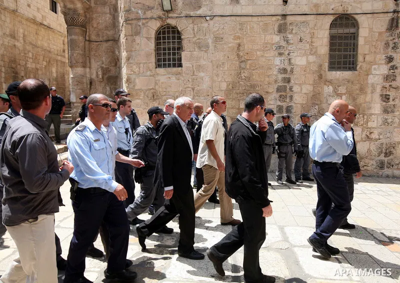 The Israeli Internal Security Minister heads to the Church of the Holy Sepulchre during the Easter "Holy Fire" celebrations on the eve of Easter Sunday on April 23, 2011, outside the Church of the Holy Sepulchre, built o...