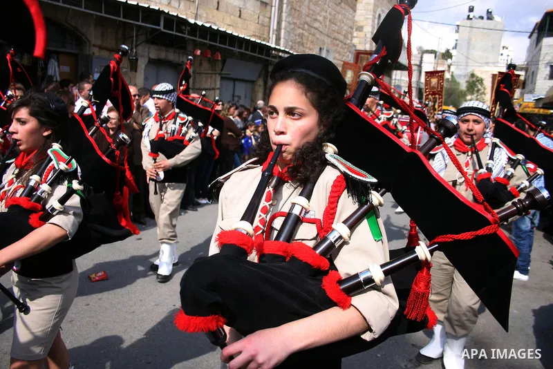 Scouts performs during Christian Orthodox annual celebrations of the "Holy Fire" in the West Bank city of Ramallah on the eve of Easter Sunday, April 23, 2011. The ceremony, celebrated in the same way for 11 centuries, i...